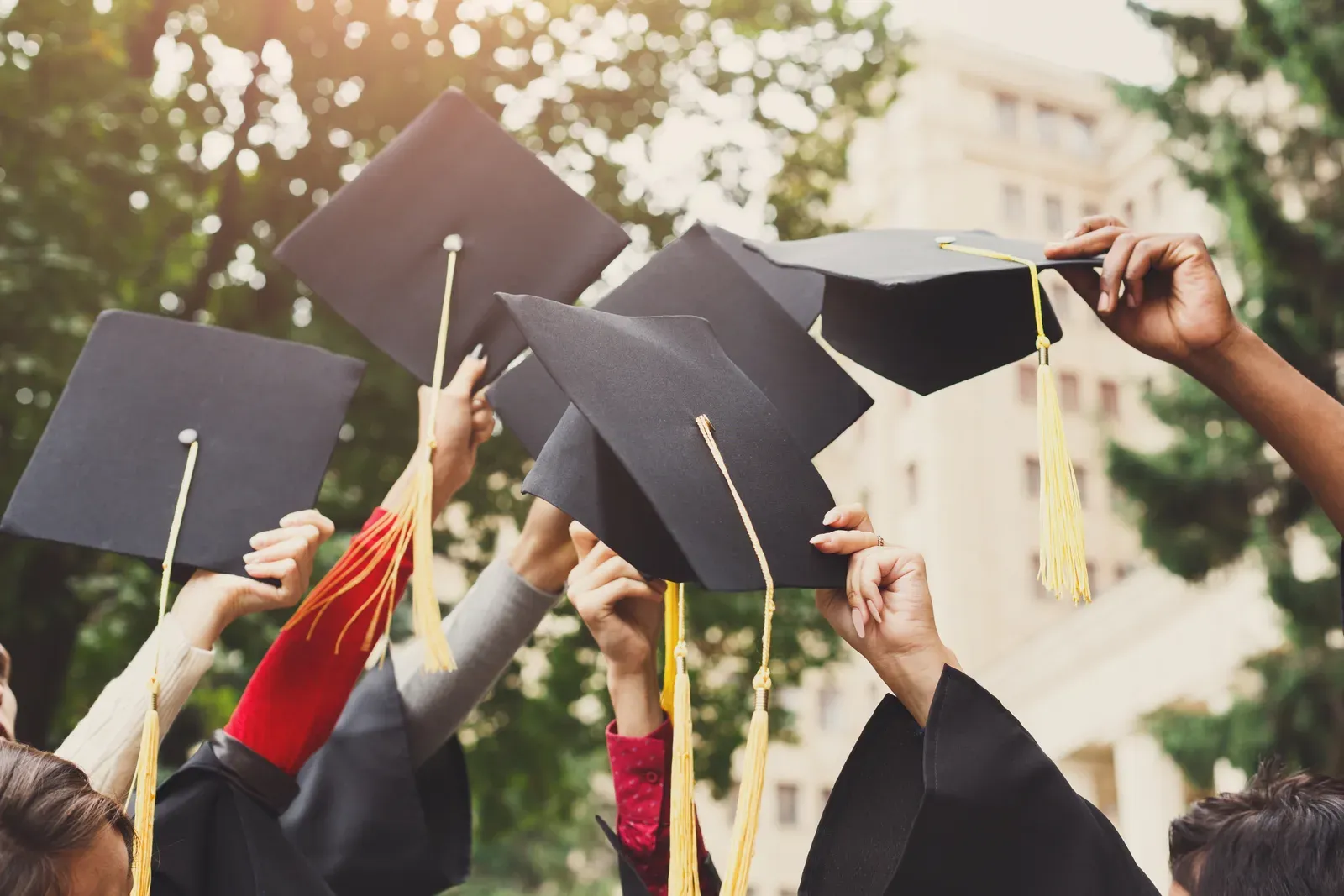 Graduates throwing their caps in the air
