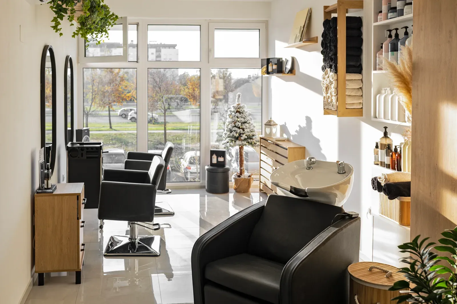 Bright hair salon with black styling chairs and mirrors