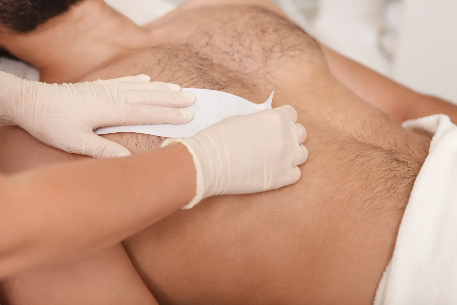 Wax hair removal treatment being applied at a salon